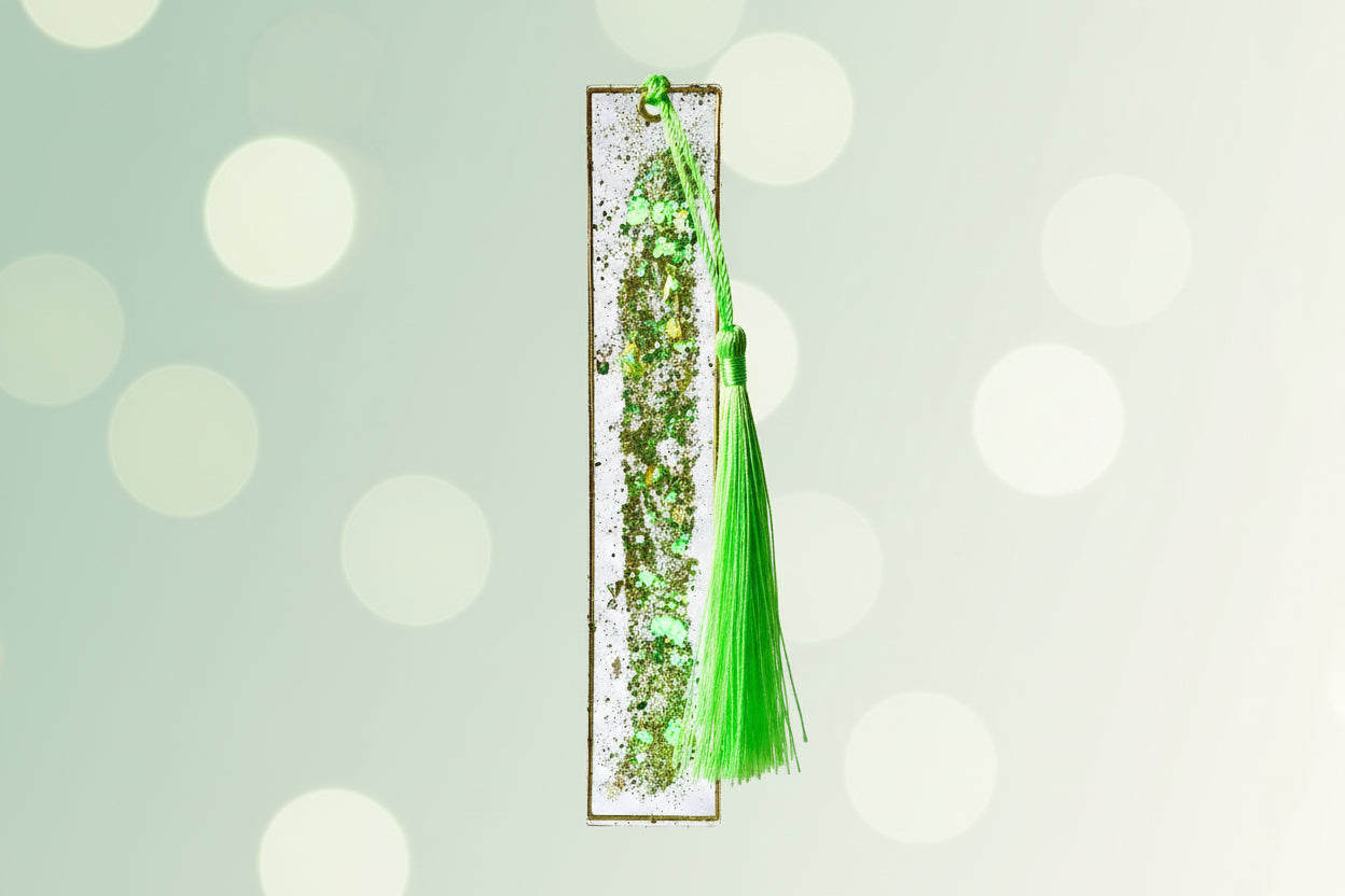 Decorative green tassel with a rectangular base on a white background