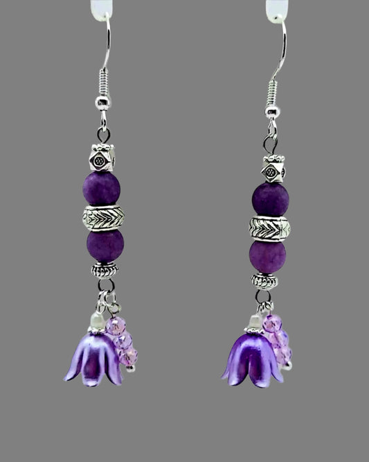 A pair of purple gemstone earrings with silver-plated daisies and spacers, designed in a floral pattern.