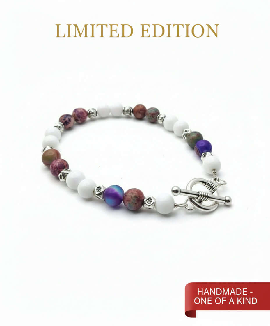 Multicolored beaded bracelet with a silver clasp on a wooden surface