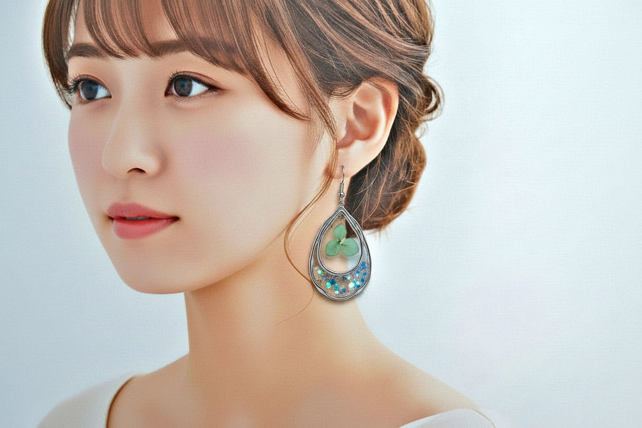 Close-up of a woman wearing a decorative earring against a light background