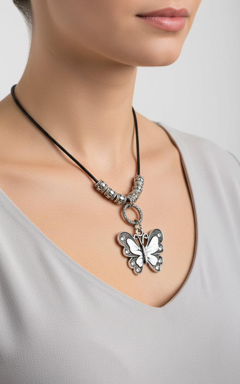 Butterfly pendant necklace on a white background