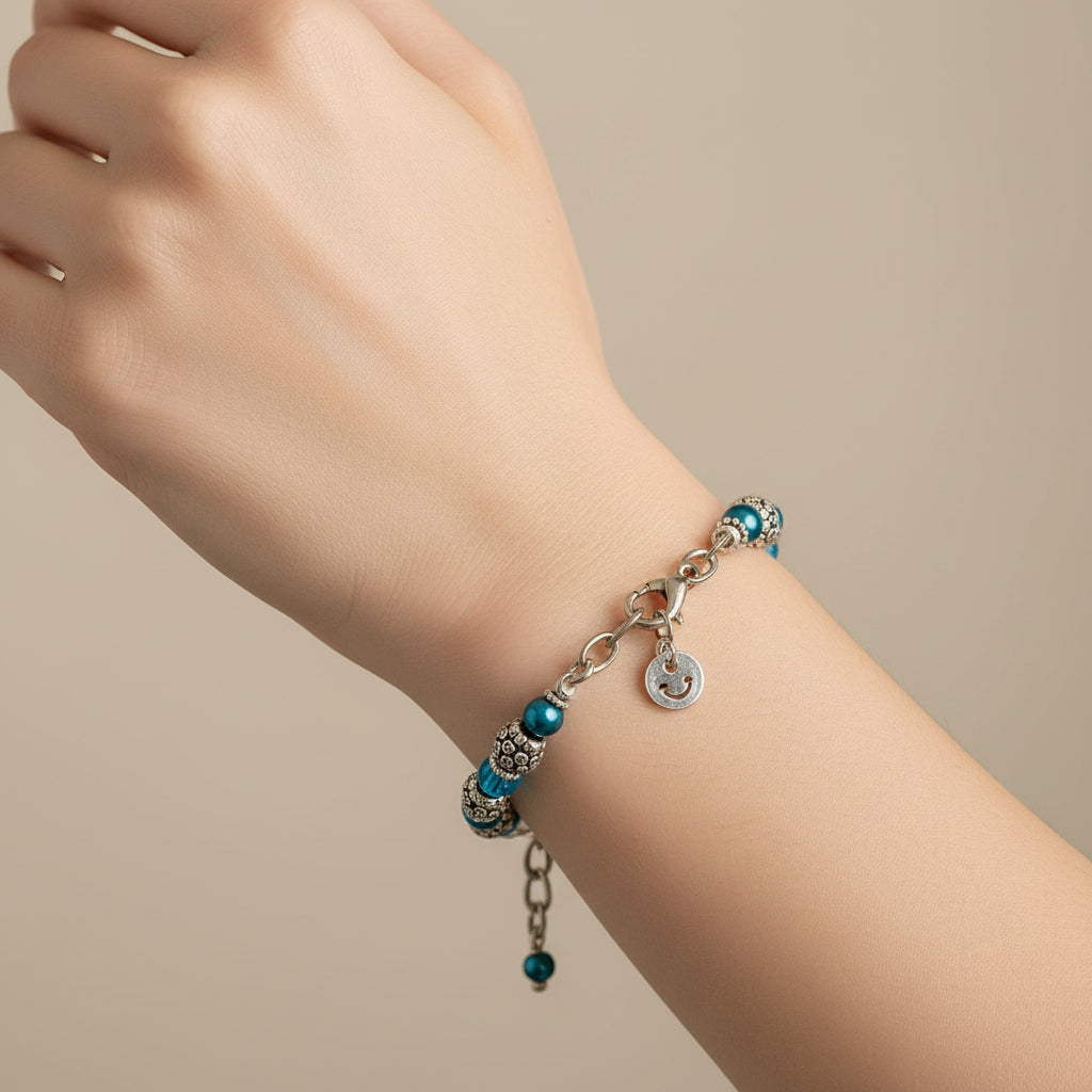 Beaded bracelet with blue and clear beads on a white stand