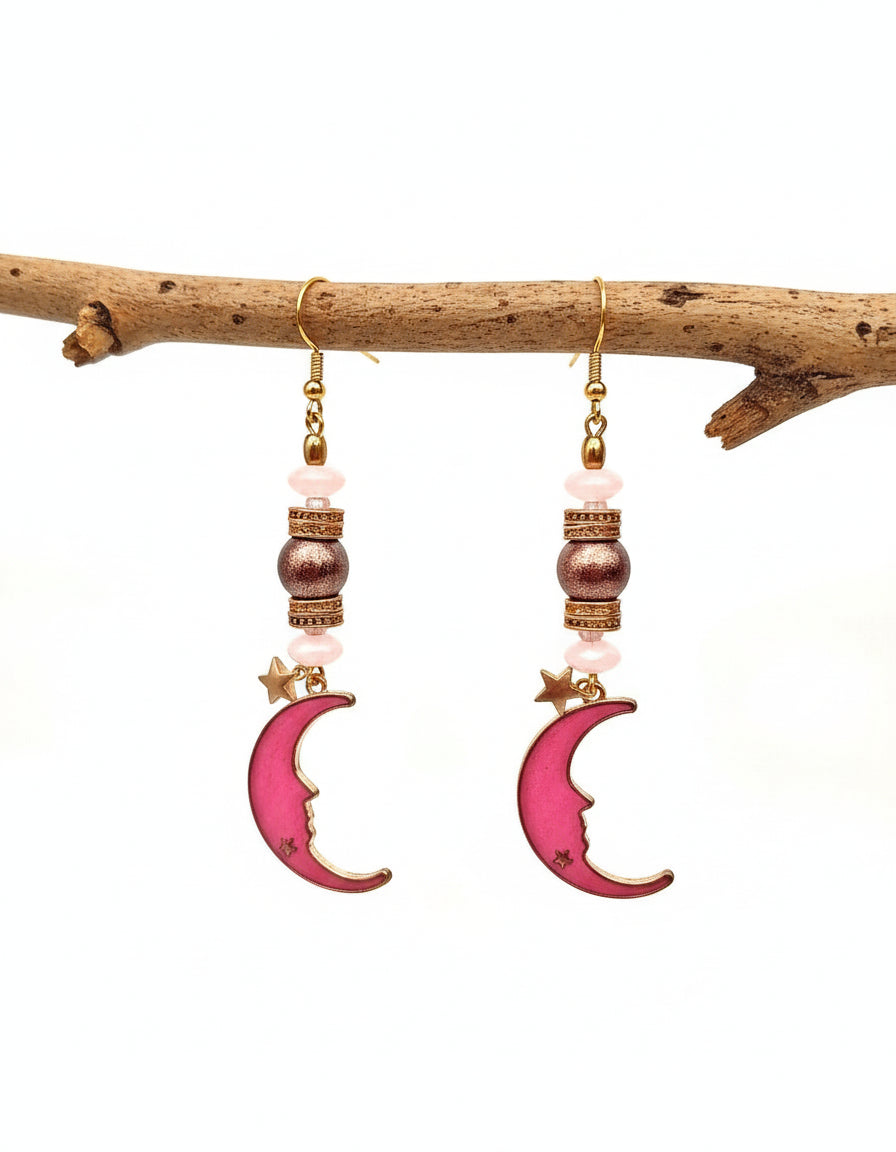 Pink crescent moon earrings with gold accents on a white background