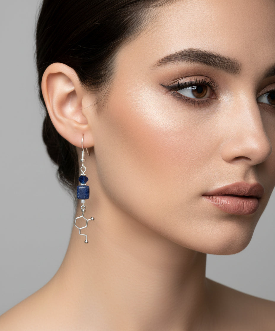 Pair of earrings with blue beads and molecular design on a branch