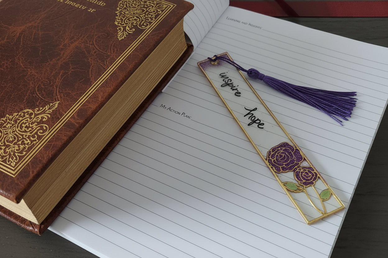 Decorative bookmark with floral design and tassel on lined paper