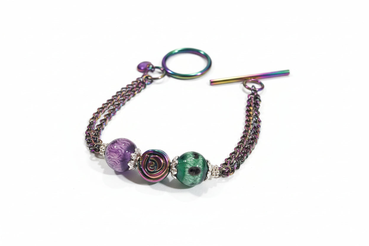 Bracelet with colorful beads and chain on a textured surface