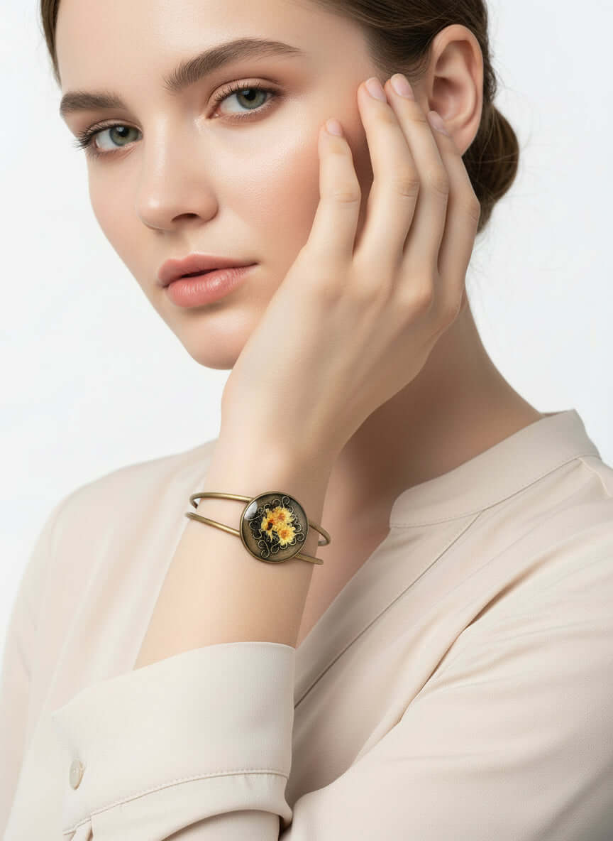 Bronze bracelet with floral design on a stone surface