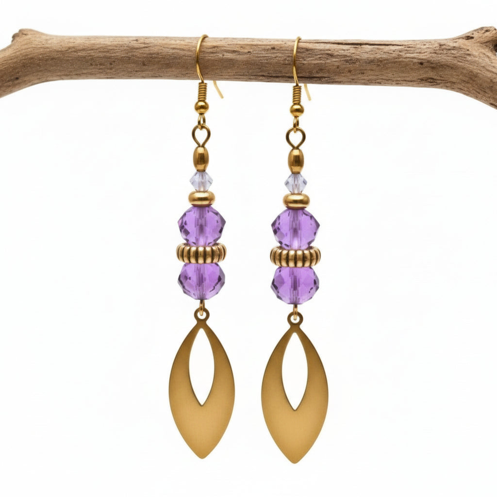 Gold earrings with pink beads on a white background