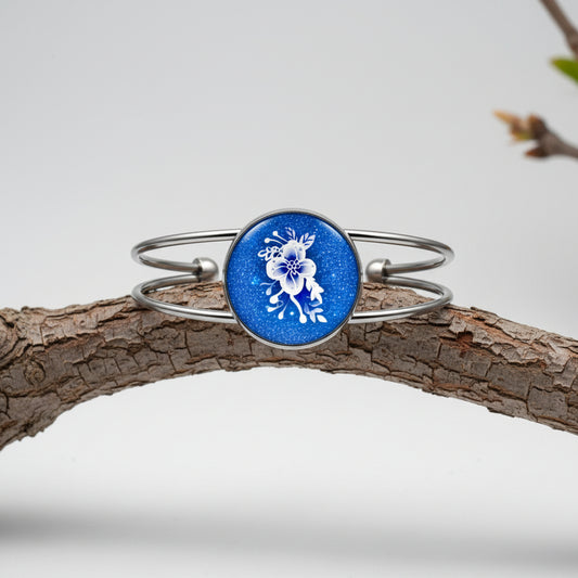 Silver bracelet with a blue round charm featuring a deer design on a white background