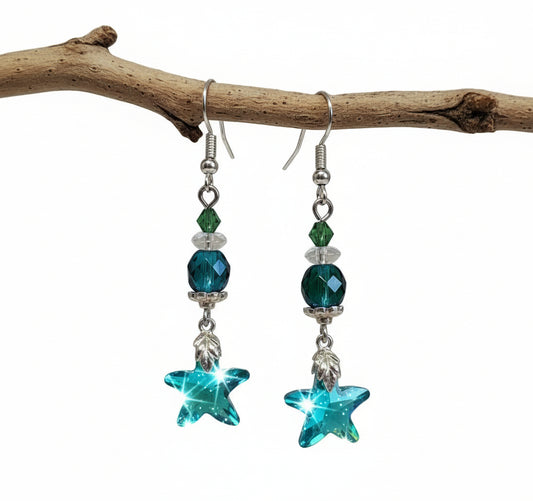Star-shaped earrings with green and blue beads on a white background