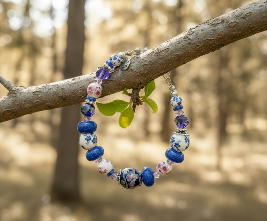 Beaded bracelet and earrings on a branch with a forest background
