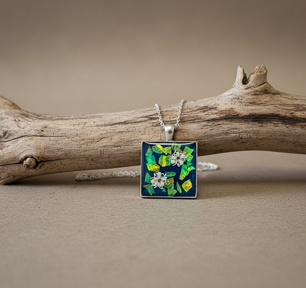 Necklace with a square pendant on a mannequin bust against a white background