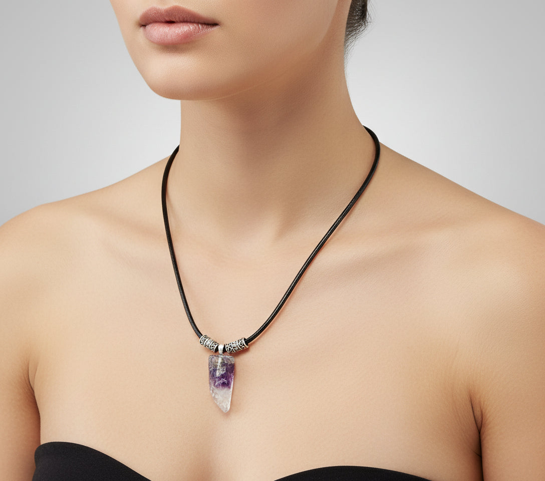 Necklace with a crystal pendant on a dark wooden surface