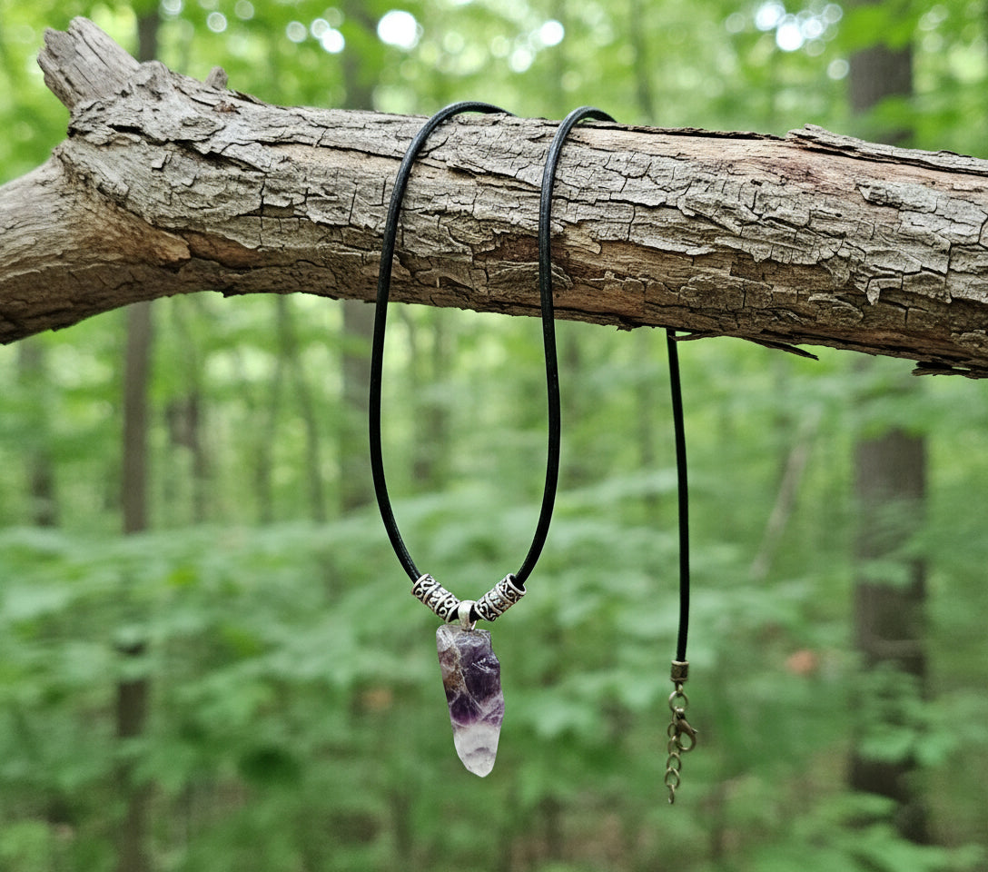 Necklace with a crystal pendant on a dark wooden surface