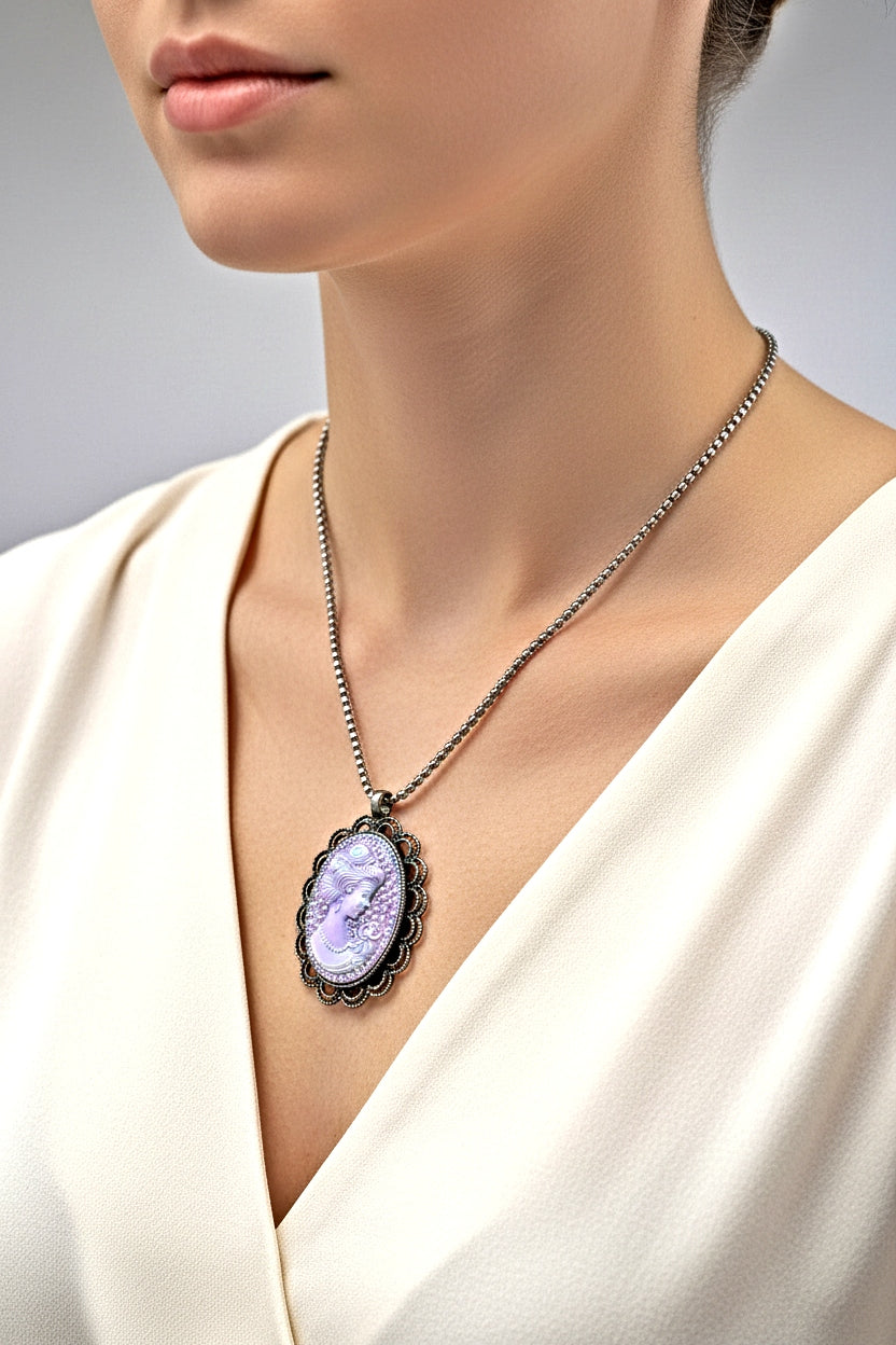 Necklace with a pendant worn by a person in a white garment on a neutral background