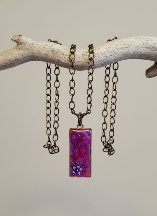 Necklace with a purple pendant on a white background