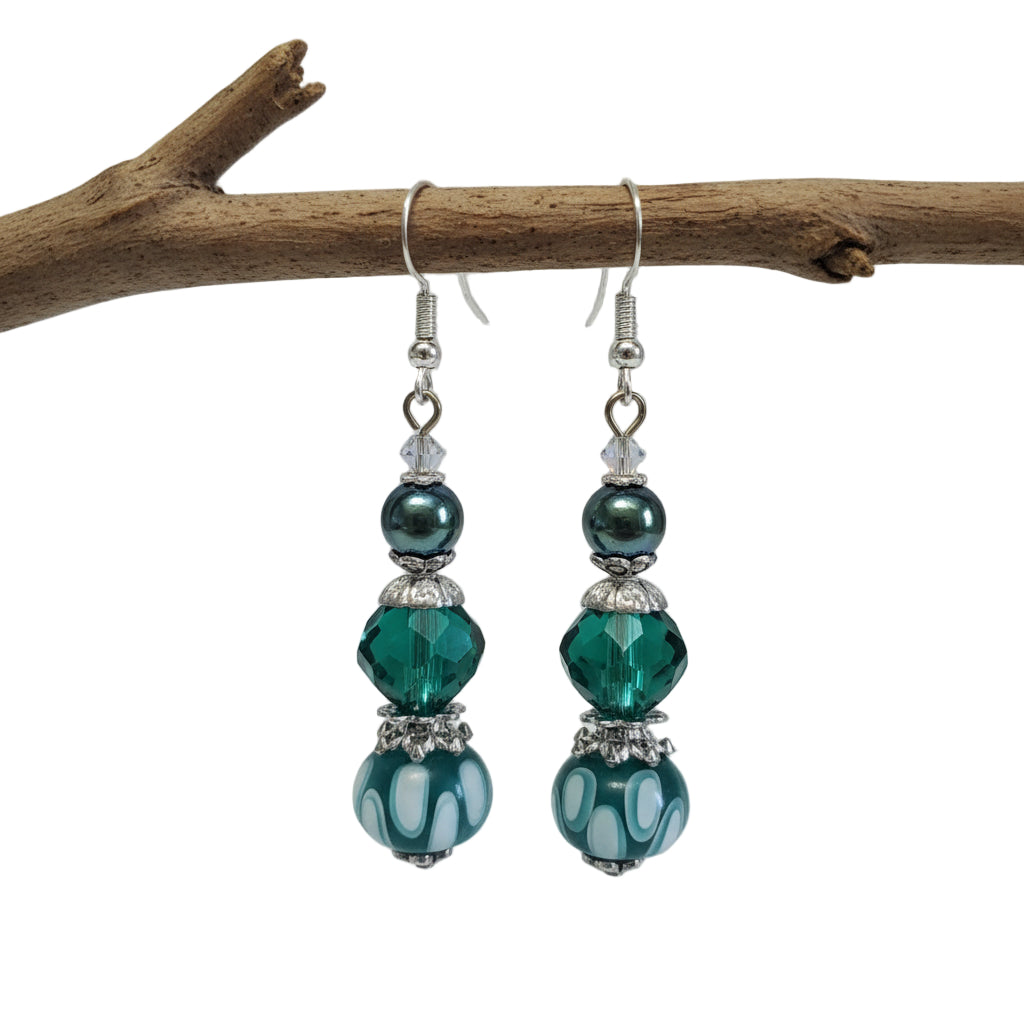 Pair of green beaded earrings on a white background