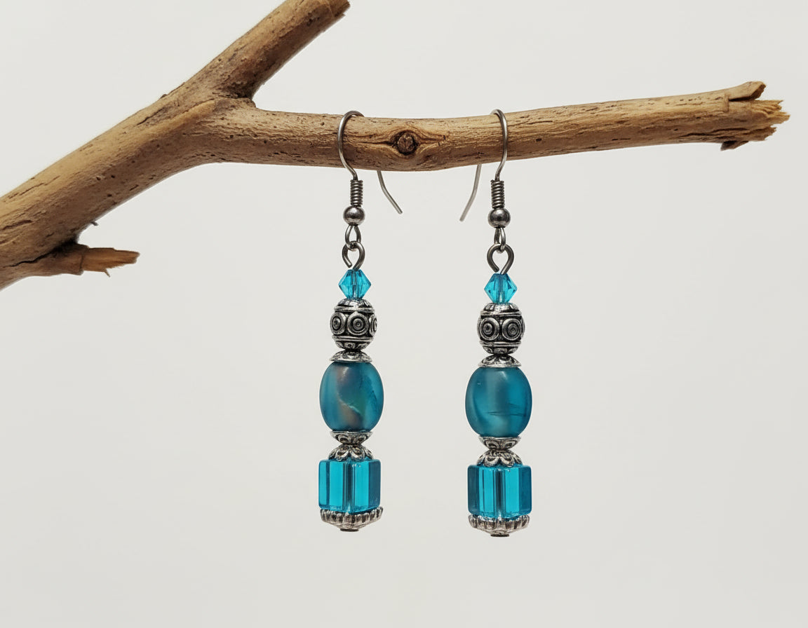 Pair of blue beaded earrings on a light background
