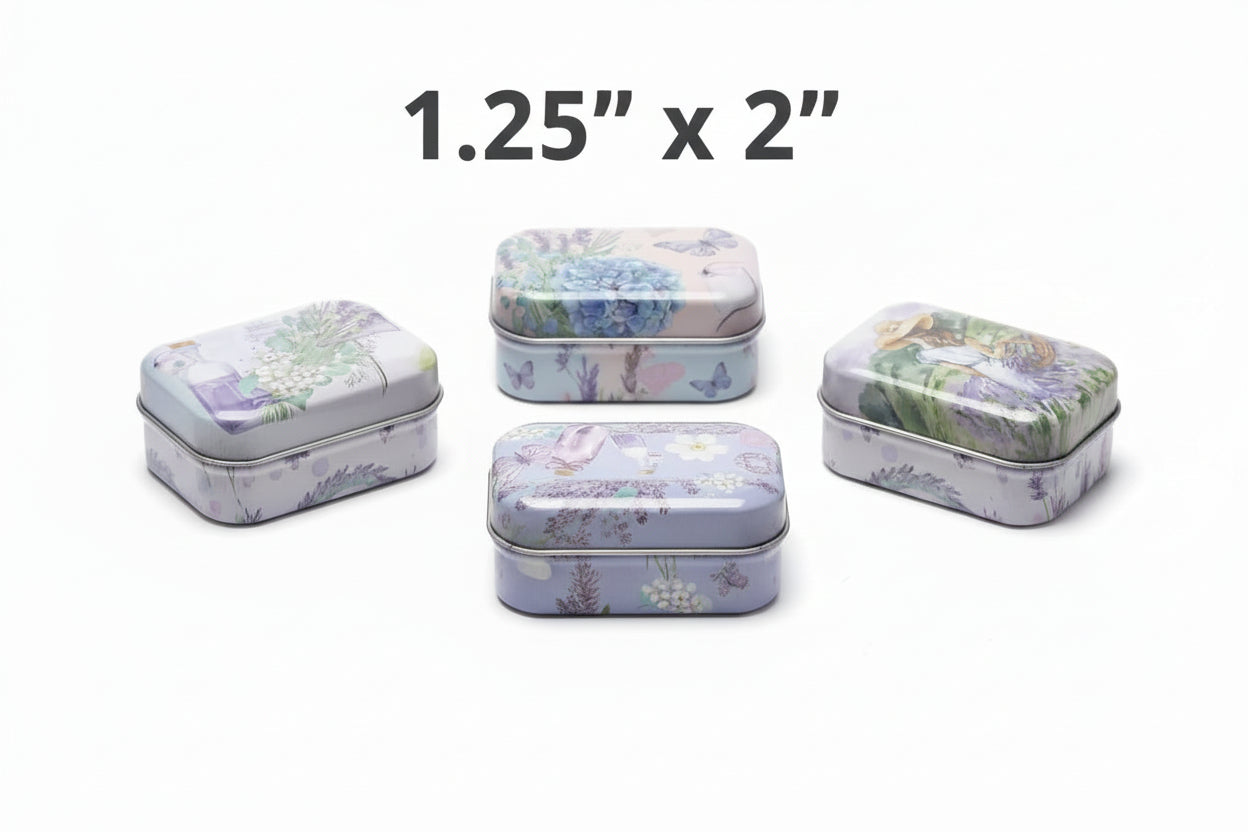 Five decorative tin boxes with floral and nature-themed designs on a gray surface.