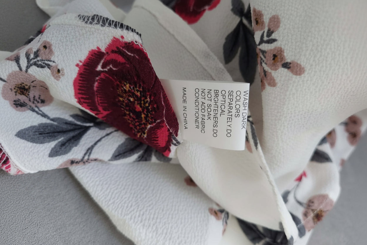 Floral fabric with a label on a gray background