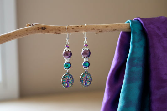Pair of earrings with purple and blue beads on a gray background