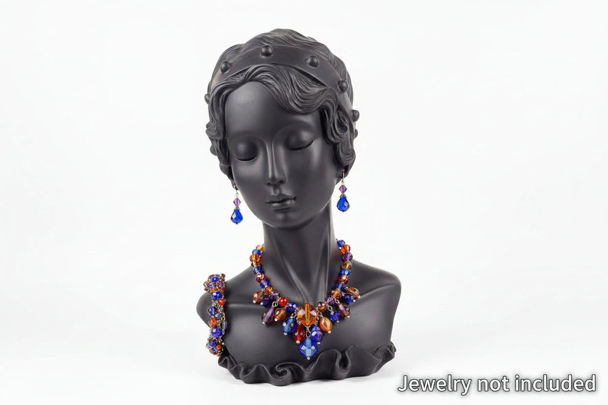 Black bust wearing a colorful necklace and earrings on a white background
