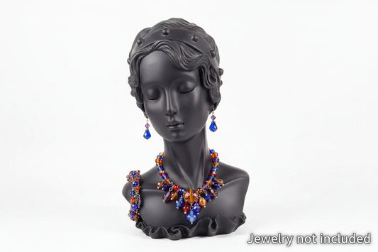 Black bust wearing a colorful necklace and earrings on a white background