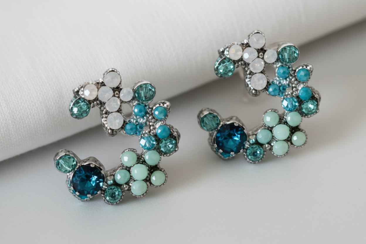 Decorative brooch with blue gemstones on a light background