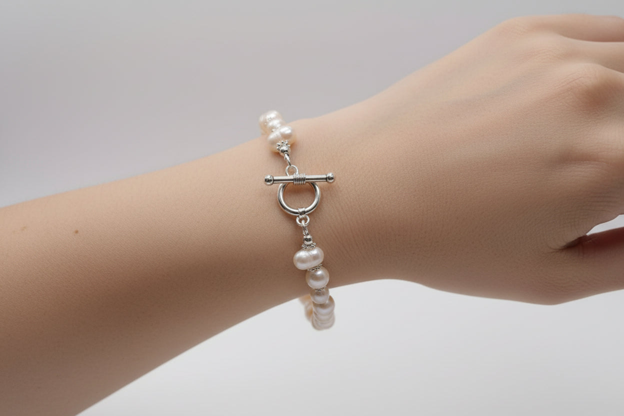 Pearl bracelet on a mannequin bust with a white background