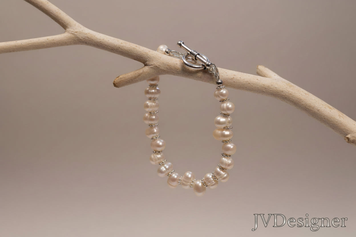 Pearl bracelet on a branch with a neutral background