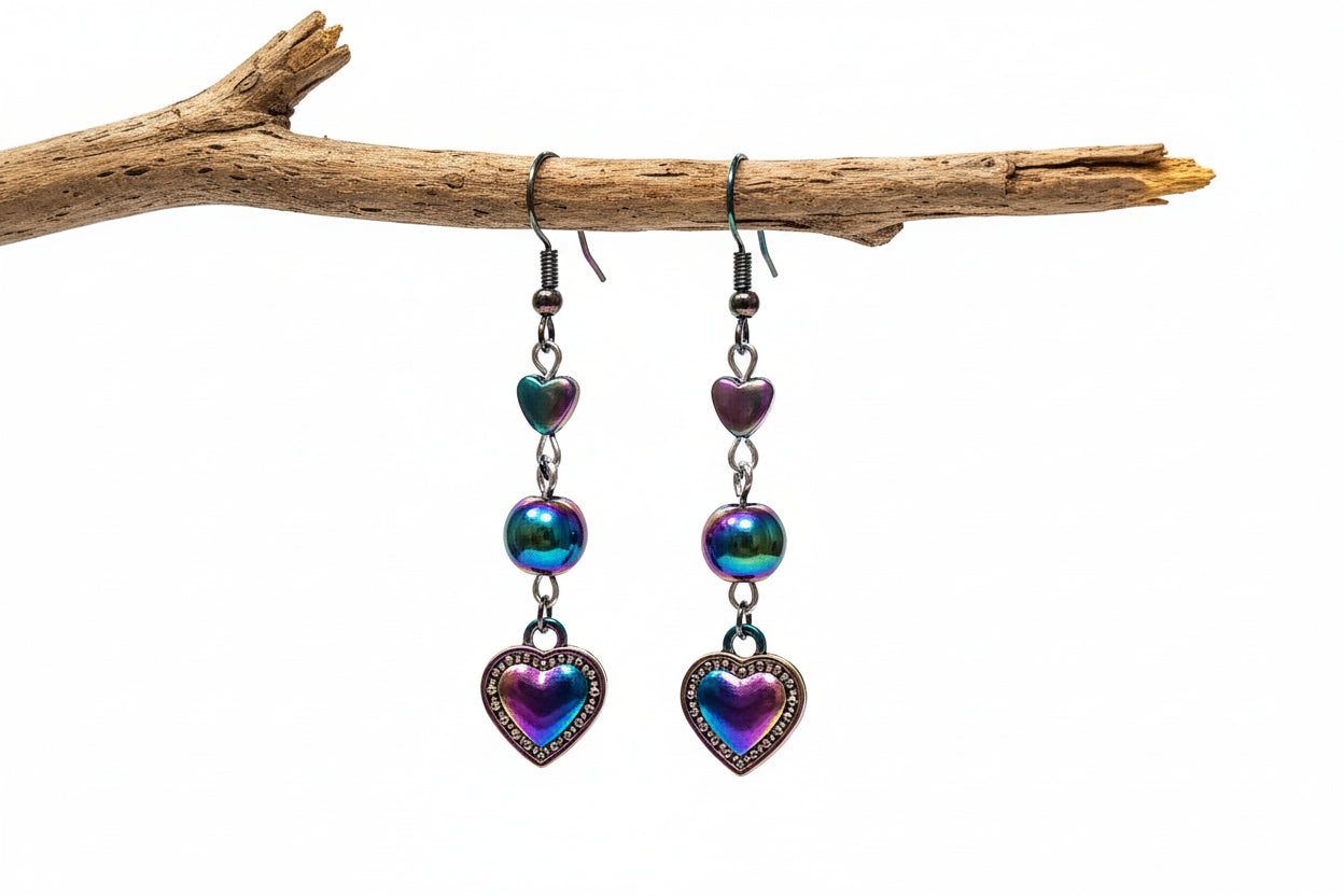 Heart-shaped earrings with colorful metallic finish on a light background