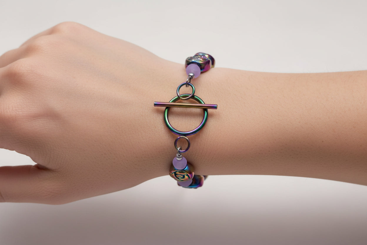 Bracelet with colorful beaded roses and purple beads on a white background