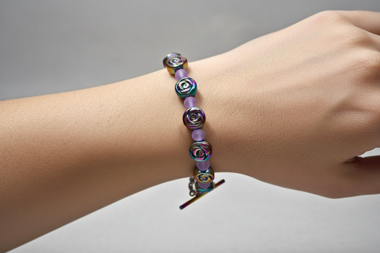 Hoop earrings with multicolored beads on a branch against a gray background