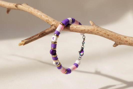 Colorful beaded bracelet with a chain on a light background