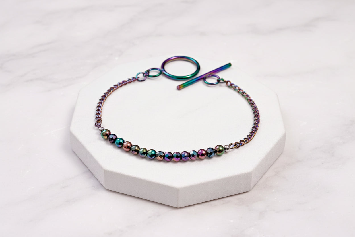 Multicolored beaded bracelet with metal clasp on a white background