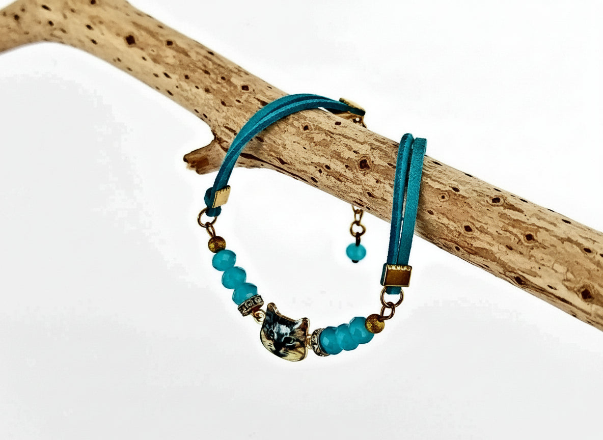 Bracelet with blue beads and gold accents on a branch