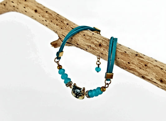 Bracelet with blue beads and gold accents on a branch