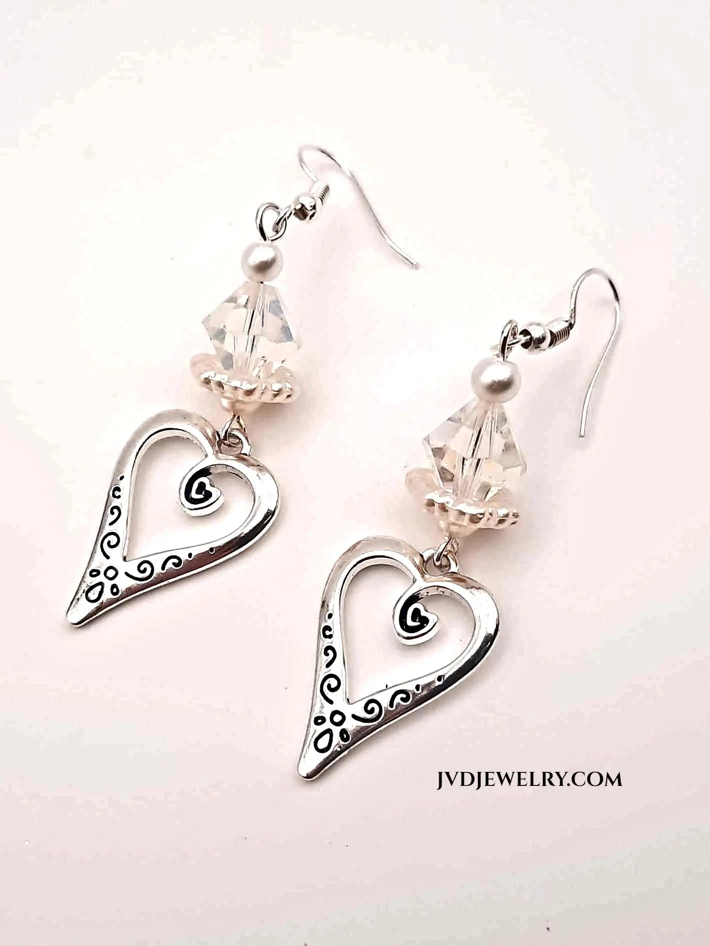 Silver heart pearlized Lucite earrings - Image #1