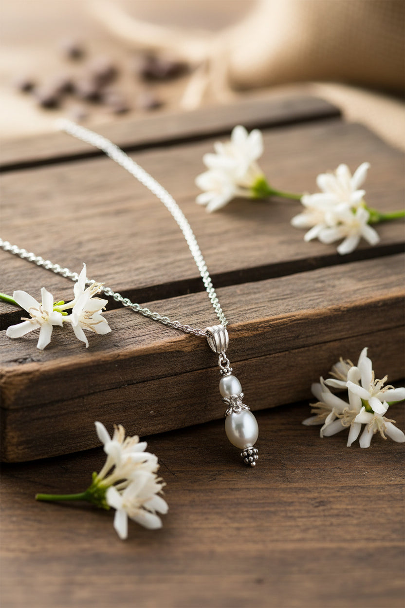 Pearl necklace with silver chain on a white background