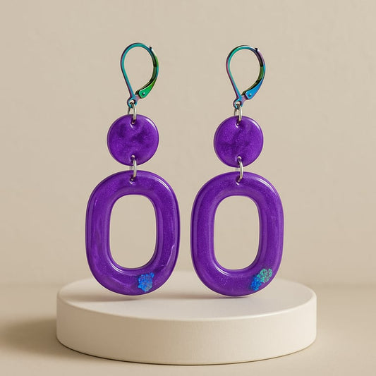 Purple earrings with a beige background